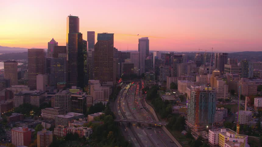 Aerial view of highways and intersections in the middle of a metropolis with modern buildings