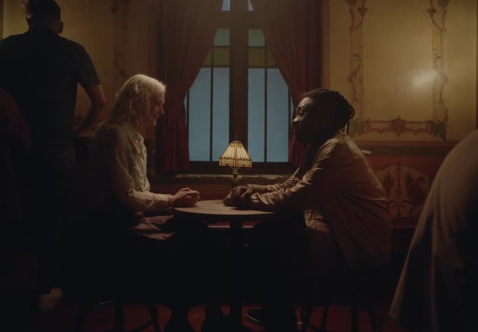 Man sitting at a restaurant table with a woman
