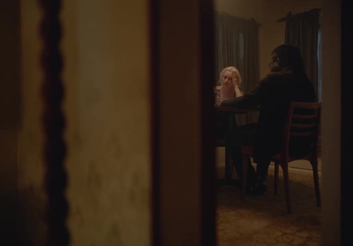 Man and a woman sitting at a table in a room