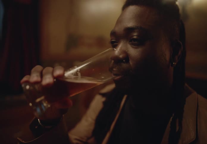 Man sitting at a table in a restaurant drinking beer