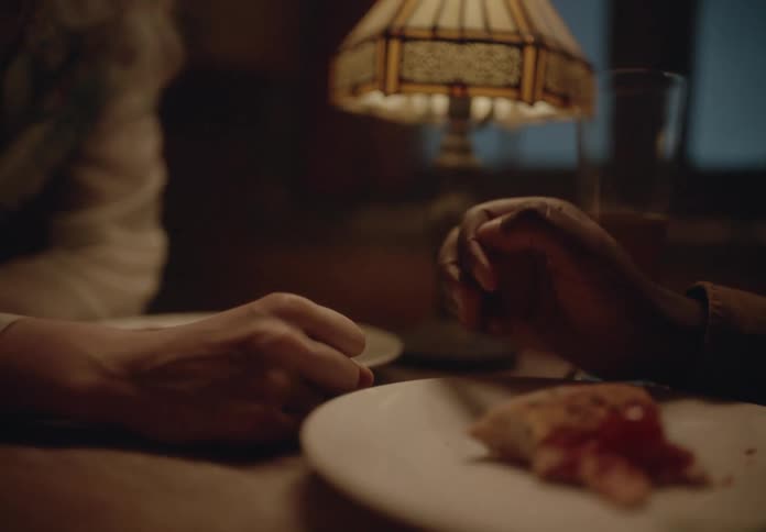 Hands of two people touching on the table