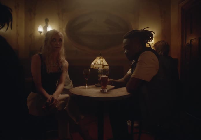 Couple has drinks in a smoky pub
