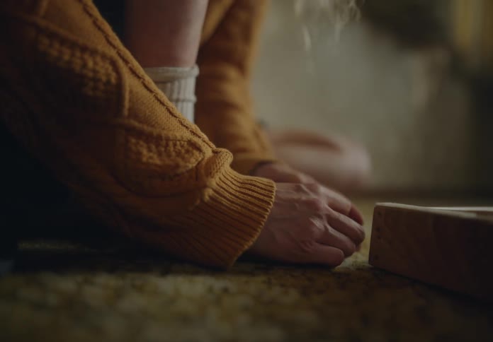 Pair of womans hands near her feet