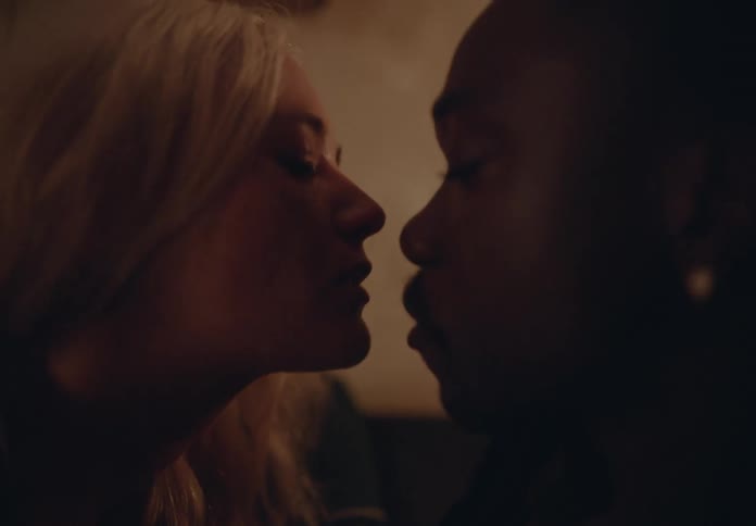Biracial sitting on the couch making out