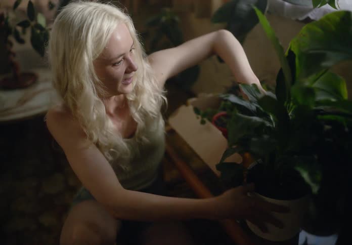 Happy couple placing plant pots in a backyard