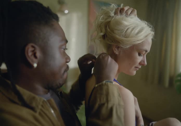 Man attaching a necklace to his partners neck