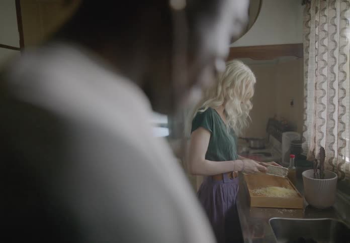 Couple in the kitchen cooking together happily