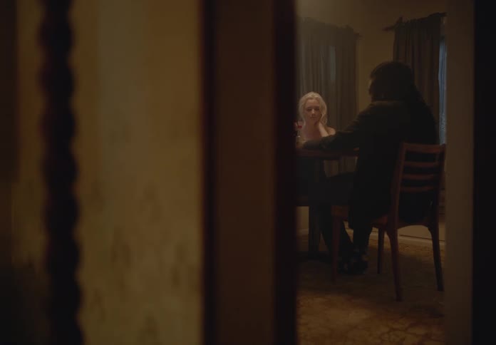 Man and woman sitting at a table talking