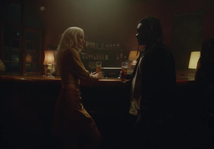 Woman and a man talking and toasting a beer and drinking it together