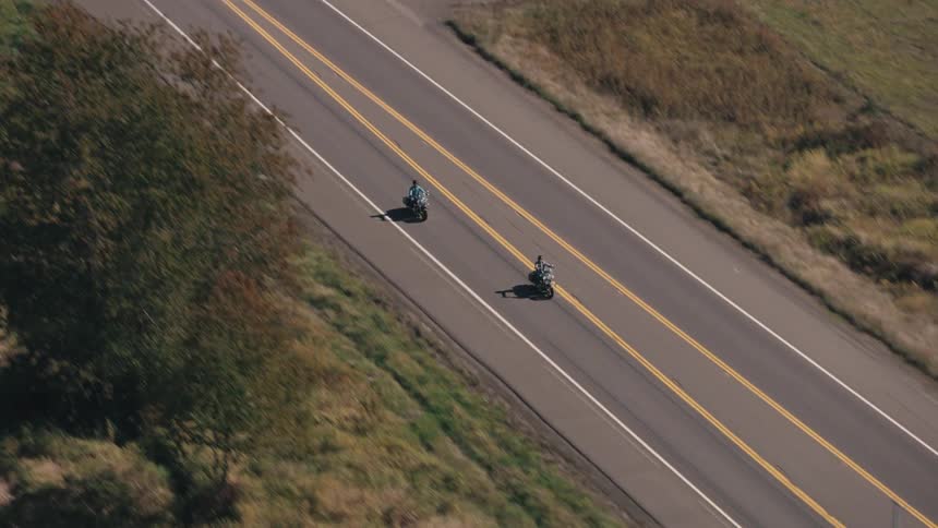 An aerial clip of motorcycles moving on the freeway