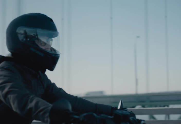 Person wearing a helmet riding a motorcycle