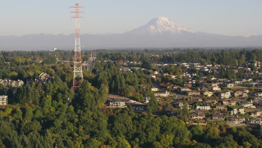 Panorama of a suburban town built on a hill with a mountain in the background