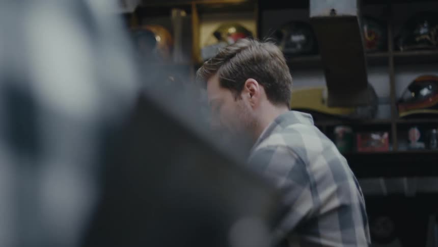 Man handling a tool while working indoors