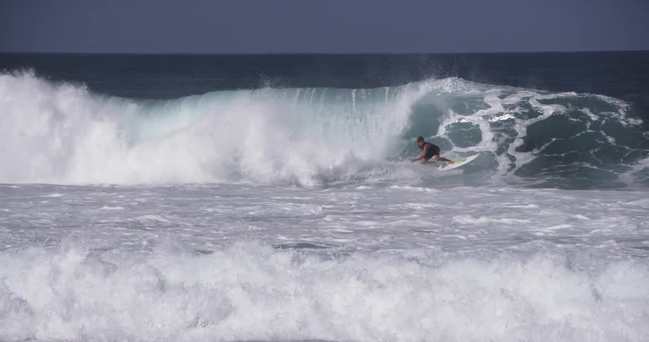 Man surfs on large waves