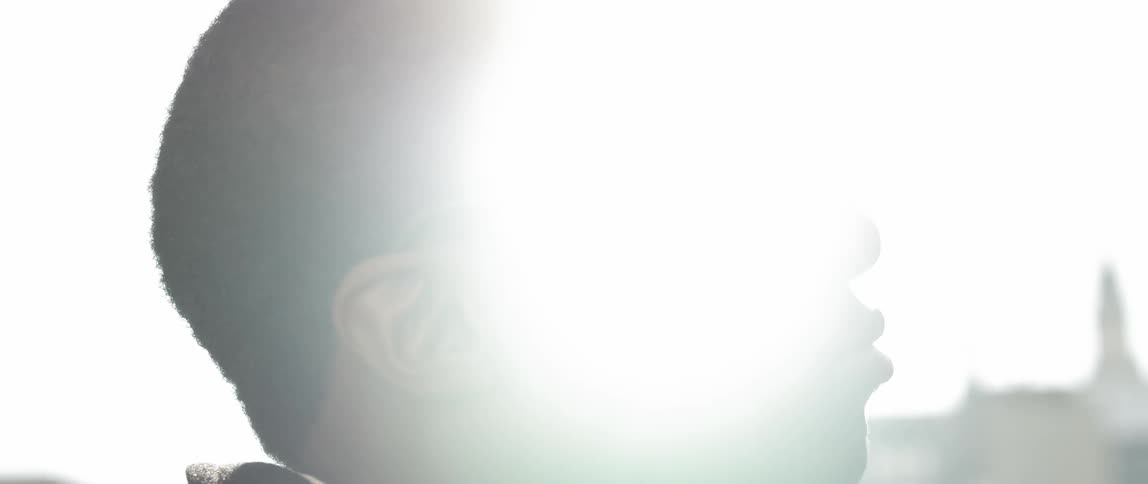 Man looking into the distance with a light shining on him