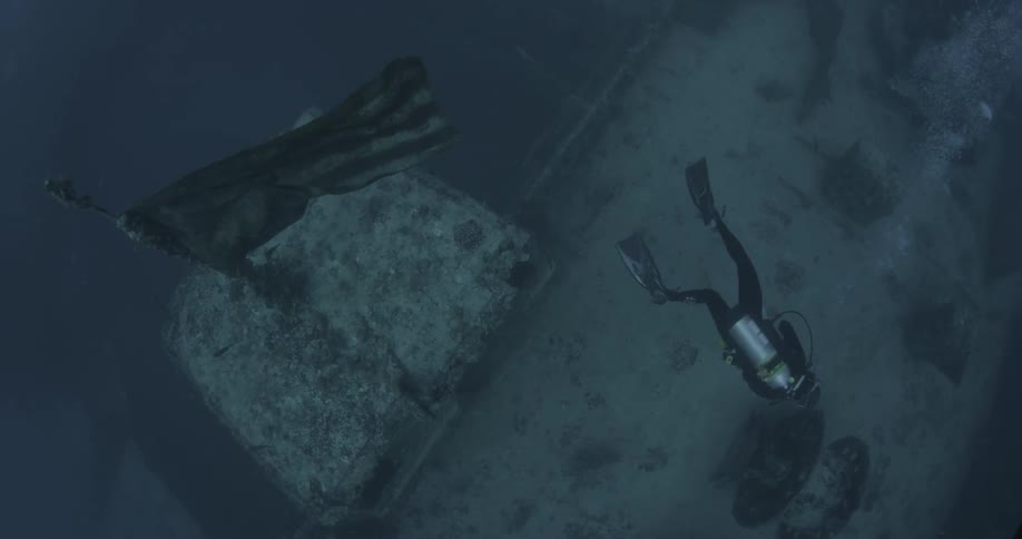 Diver explores a sunken ship