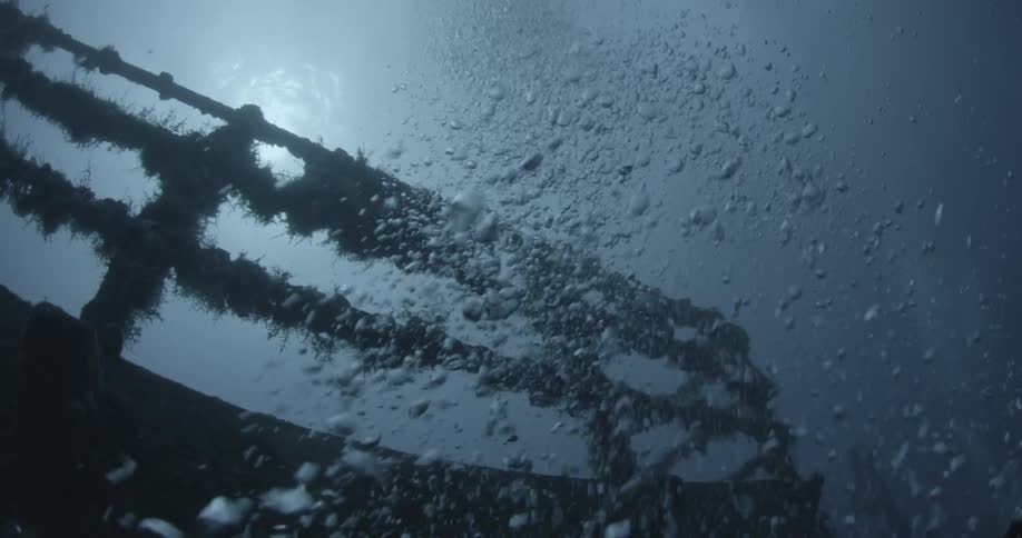 Bubbles float around ship wreckage in the ocean