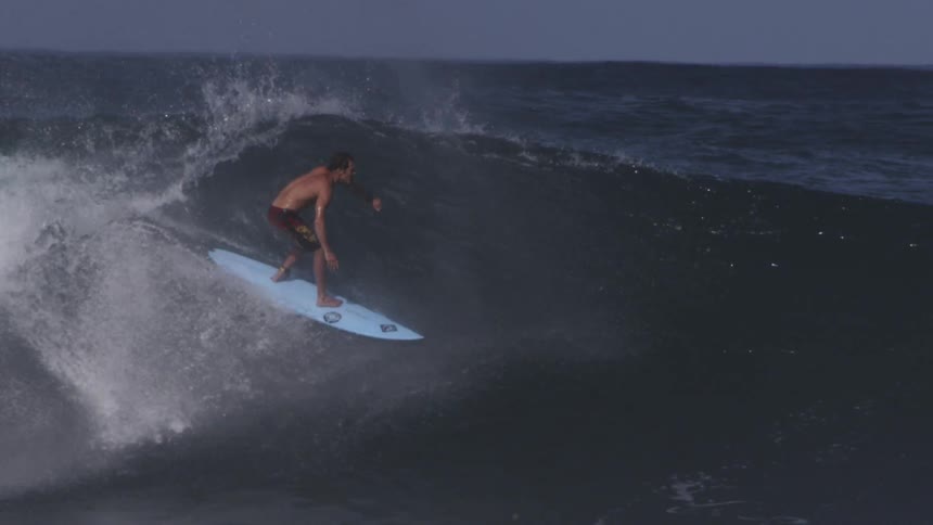 Man surfs on large waves