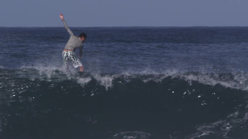 Person surfing large ocean waves