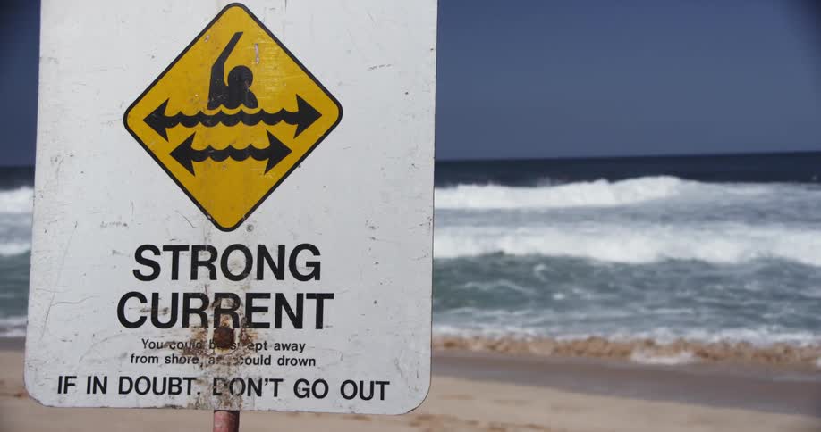 View of a sign next to a beach