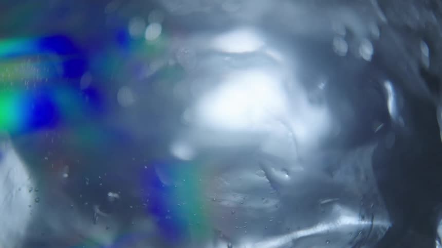 The ice reflects light as it spins
