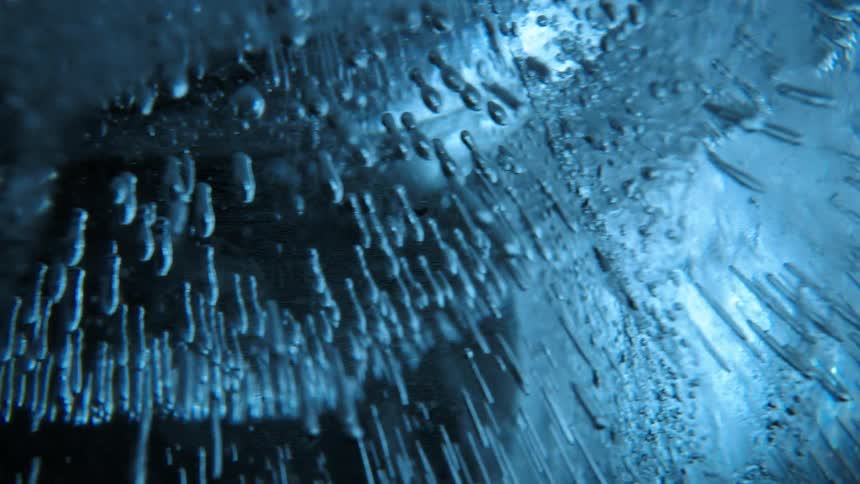 Extreme close up of ice with water cracks