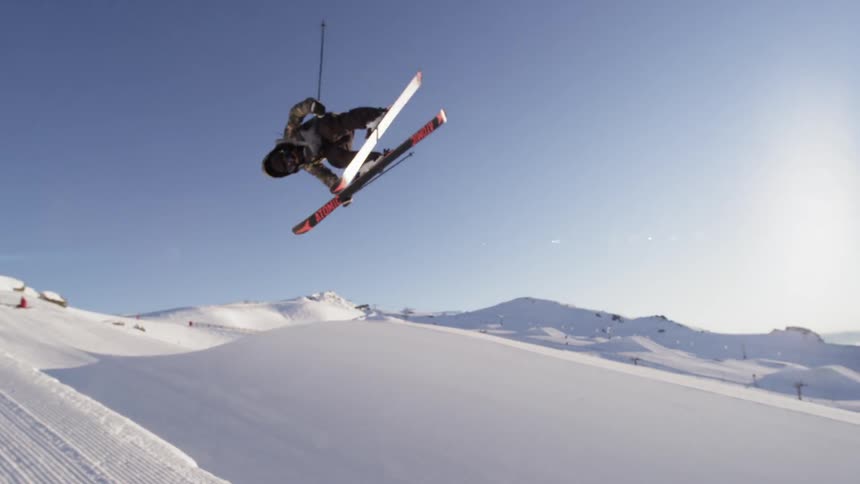 A person does tricks while skiing