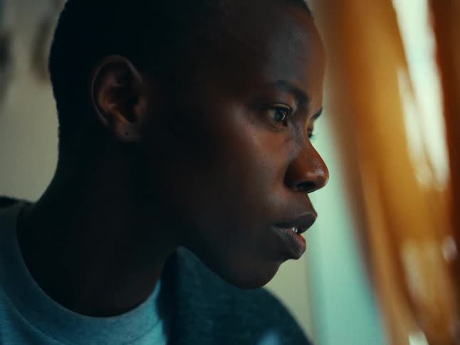 A young woman reads from a screen moving her lips