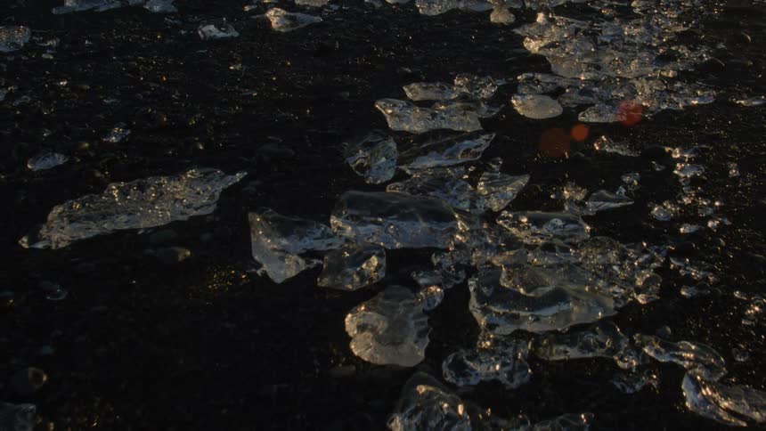 Ice chunks glitter on a black sand beach