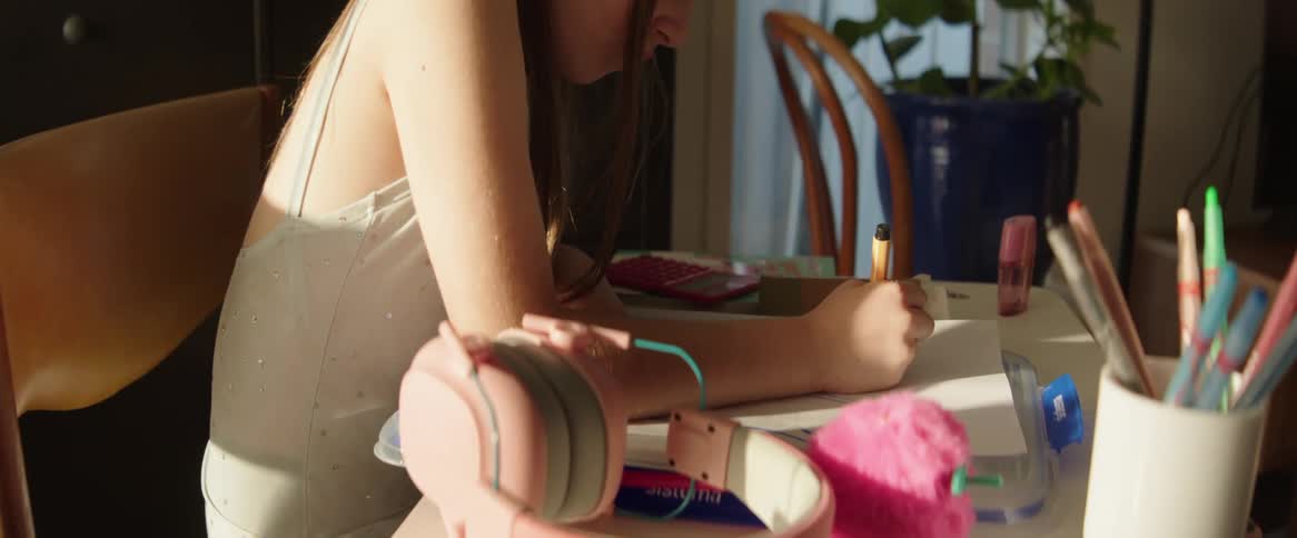 A girl is using a marker to make a drawing