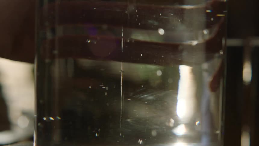 Bubbles rise in the pitcher as water fills it
