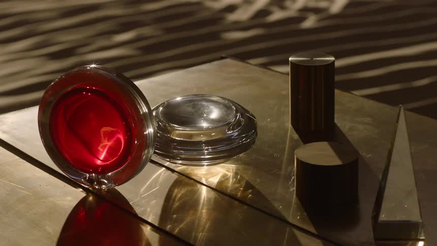 Geometric shapes of glass and metal on a surface with sunlight reflection