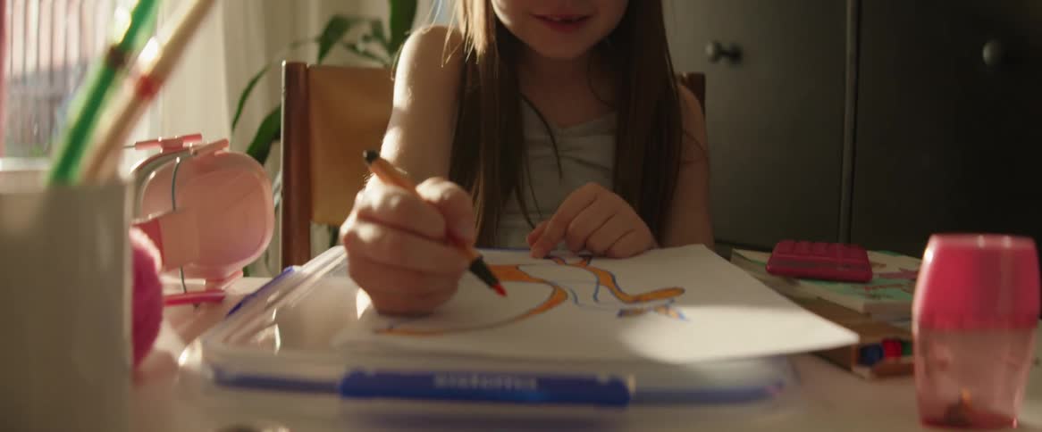Little girl sitting drawing