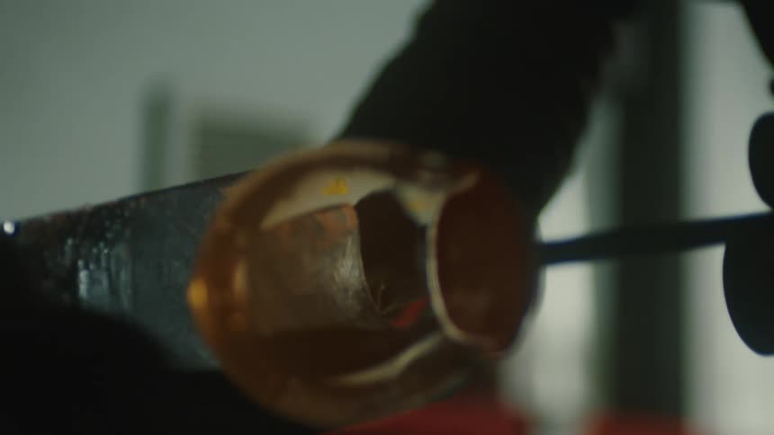 Silhouette of a person placing an object beneath a forged glass