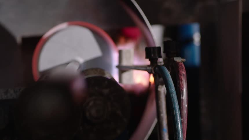 Closeup of a machine releasing a jet of fire