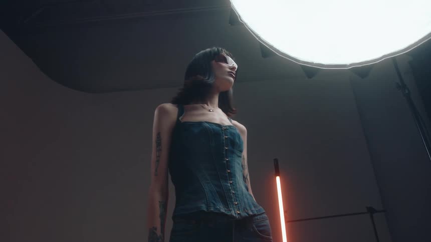 A woman is posing under the lights
