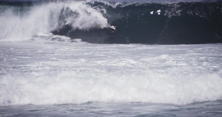 A surfer rides an ocean wave