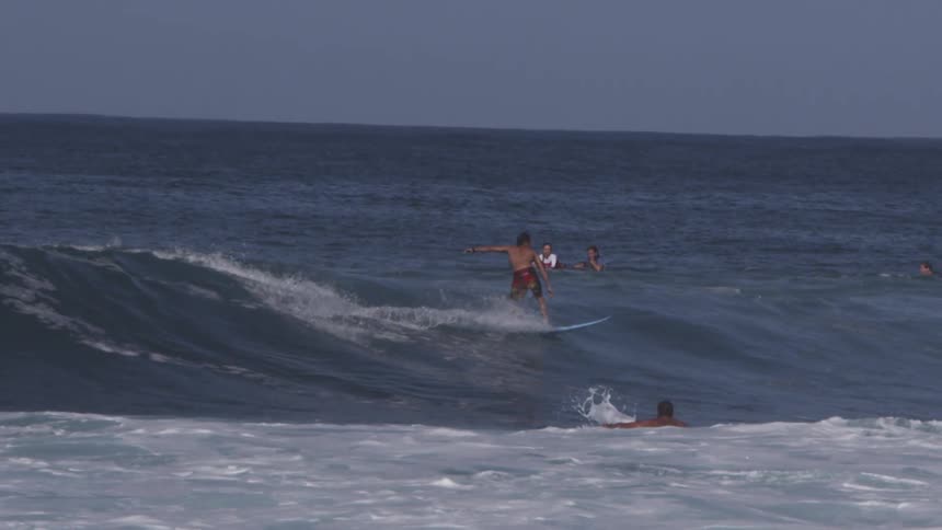 A surfer rides an ocean wave