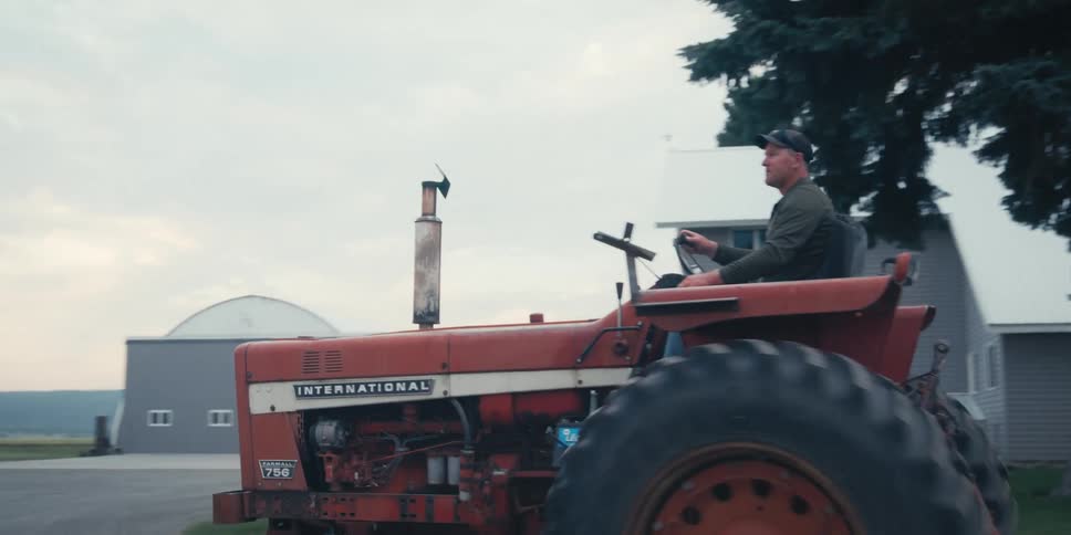 A man rides a tractor