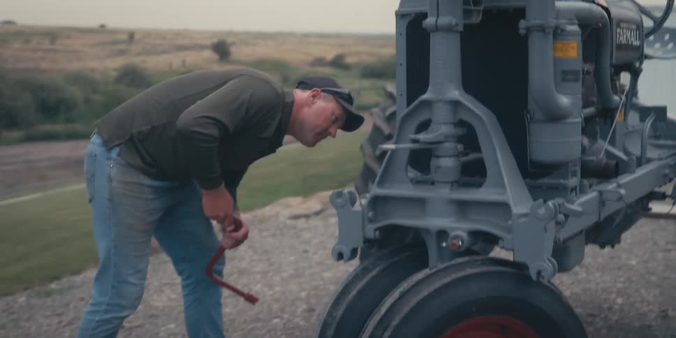 A man inspects a tractor