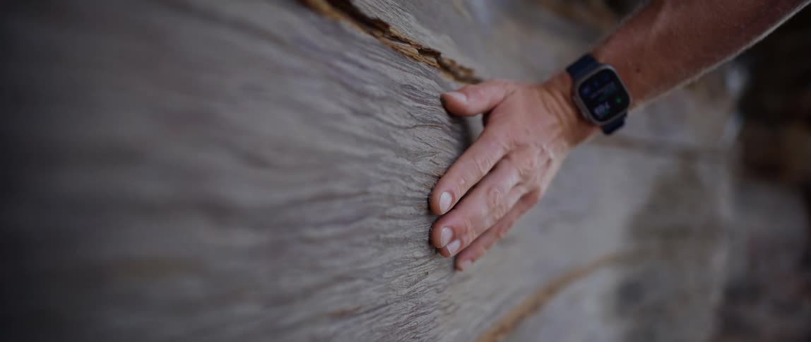 Human hand passing over a wooden surface