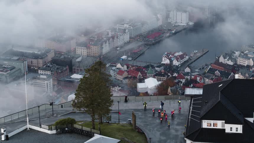 People walk out of the building and into the parking lot on a foggy day