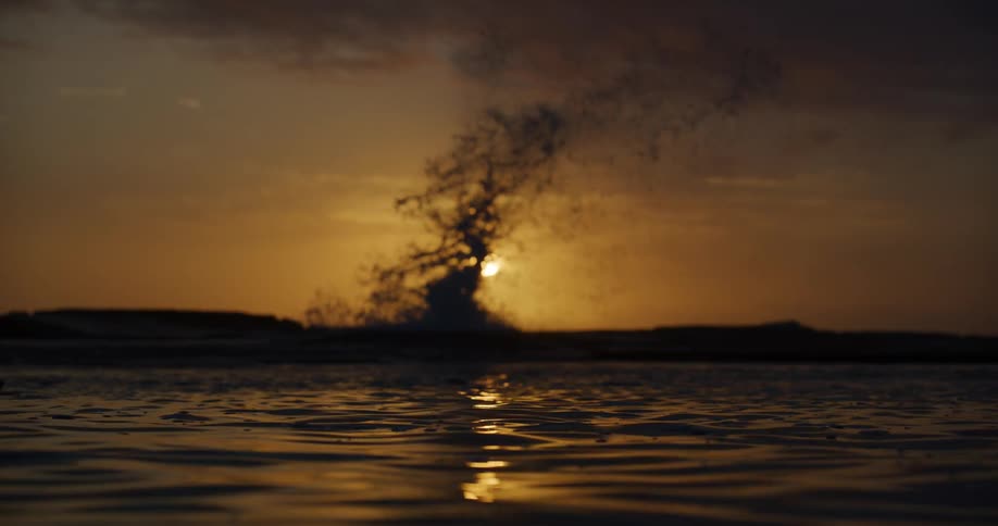 A wave makes a large splash on the shore