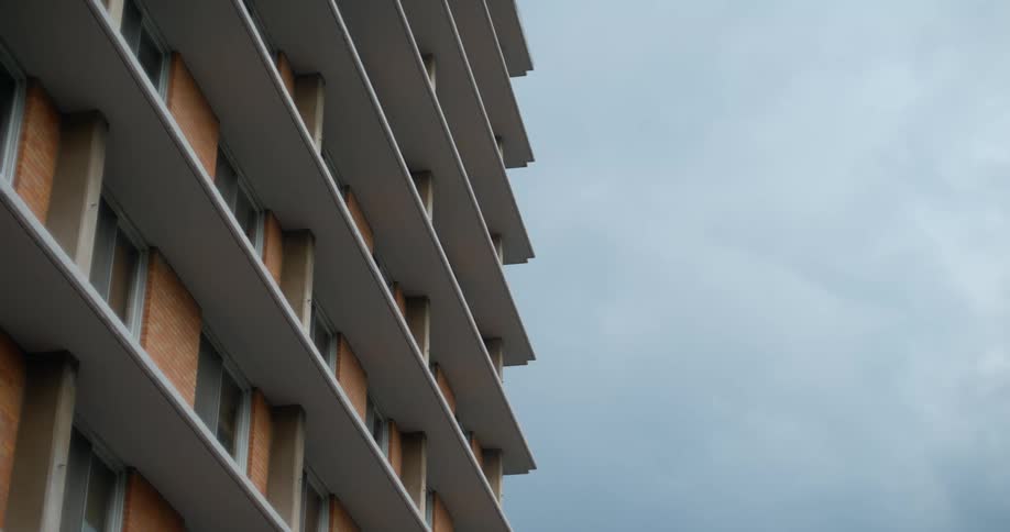 Exterior architecture of an urban building against a cloudy sky