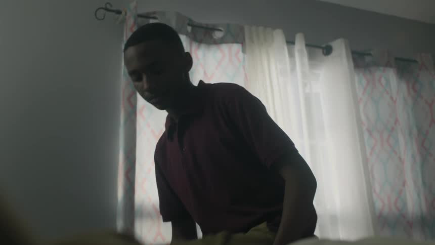 A boy walks over and sits down