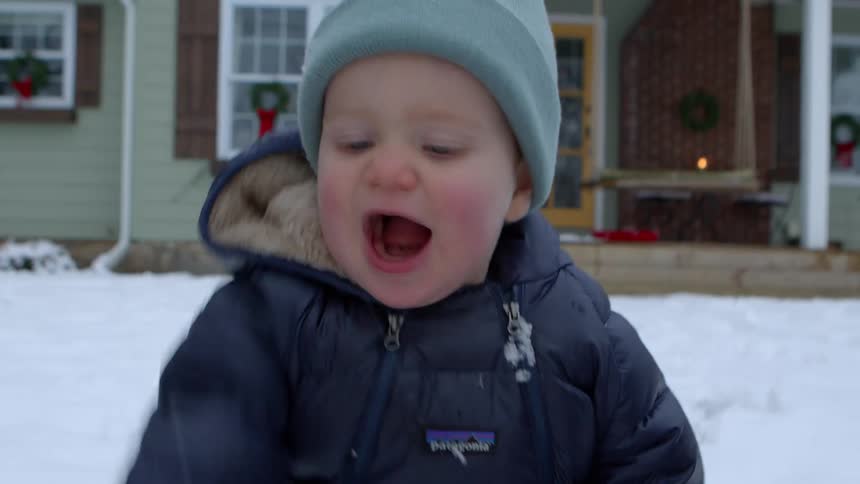 A clip of a kid playing with snow