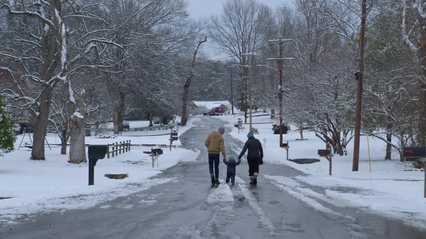 A clip of a family walking out in the cold