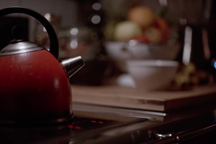 Kettle emitting smoke while sitting on a stove