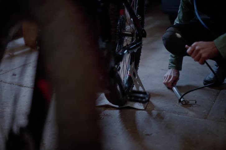 Person inflating a bicycle tire