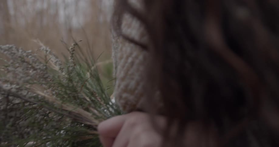 A woman carries picked flowers